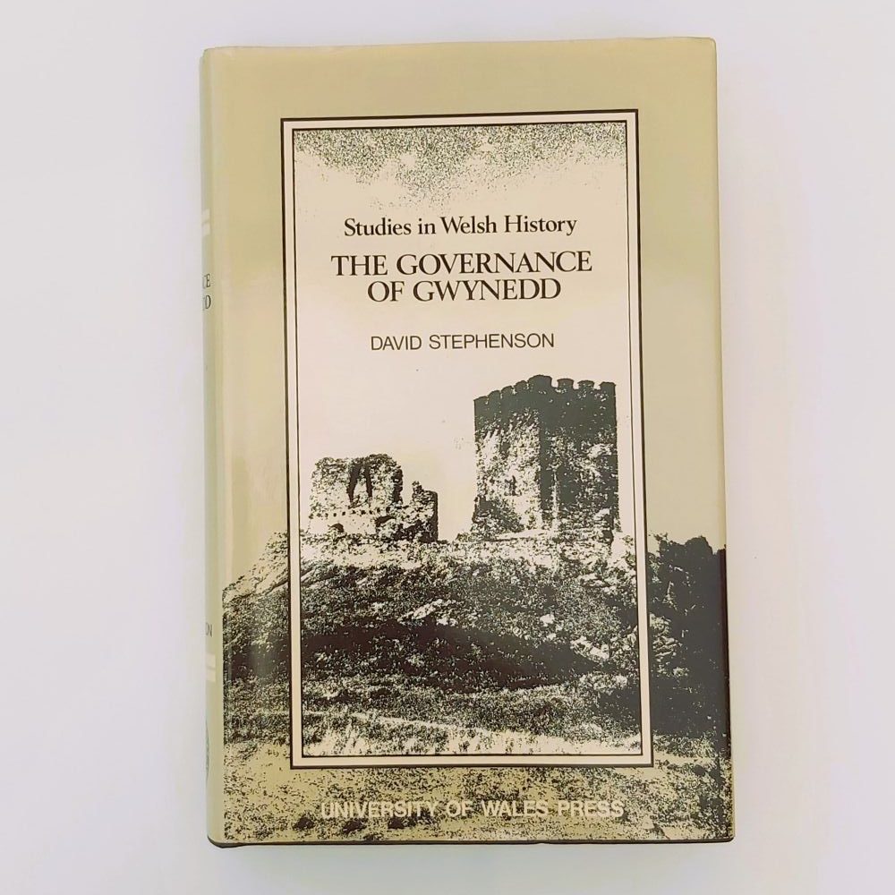 Governance of Gwynedd Front view of the book's pale cream paper dust jacket, featuring the title text "Studies in Welsh History: THE GOVERNANCE OF GWYNEDD" and author name "DAVID STEPHENSON" alongside a monochrome sketch of a medieval castle.Stephenson (2)a