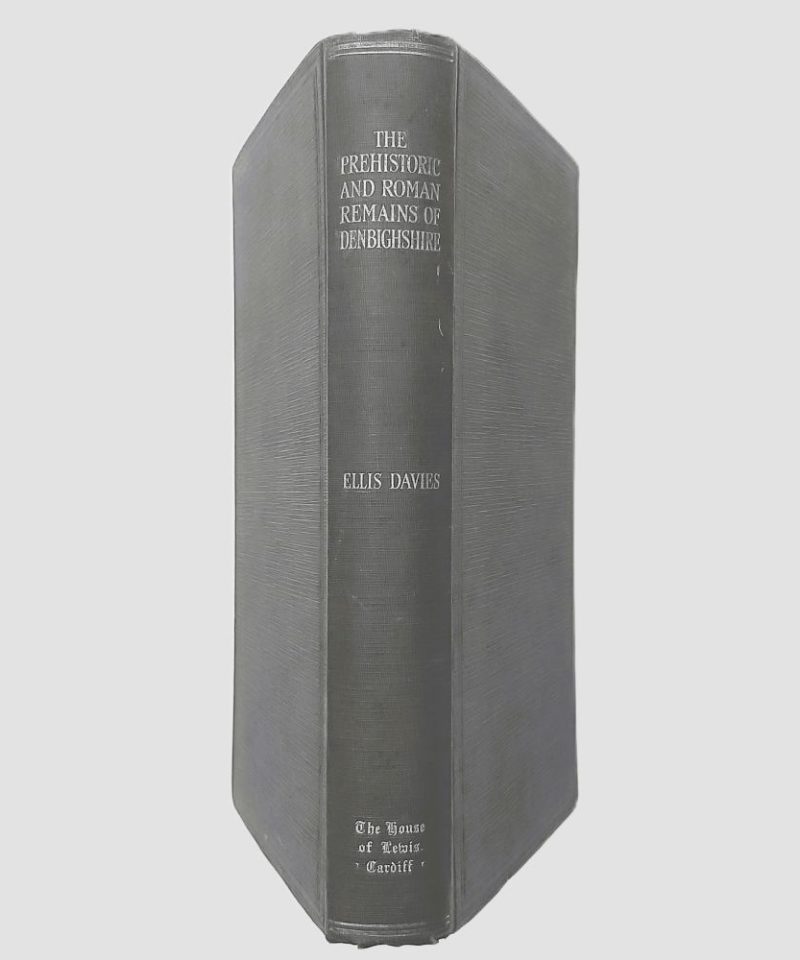 Prehistoric and Roman Remains of Denbighshire Davies (6)a Standing spine view of the book bound in dark green cloth, showing legible silver or white stamped lettering reading "THE PREHISTORIC AND ROMAN REMAINS OF DENBIGHSHIRE", "ELLIS DAVIES", and the publisher logo at the base.