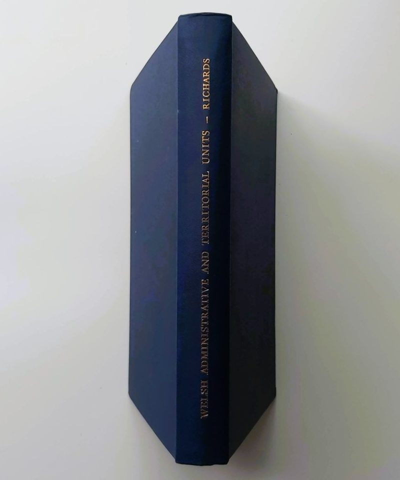 Welsh Administrative and Territorial Units Richards (3) Standing spine view of a hardback book bound in dark blue cloth, featuring crisp gilt-stamped lettering for the title, author surname, and publisher.